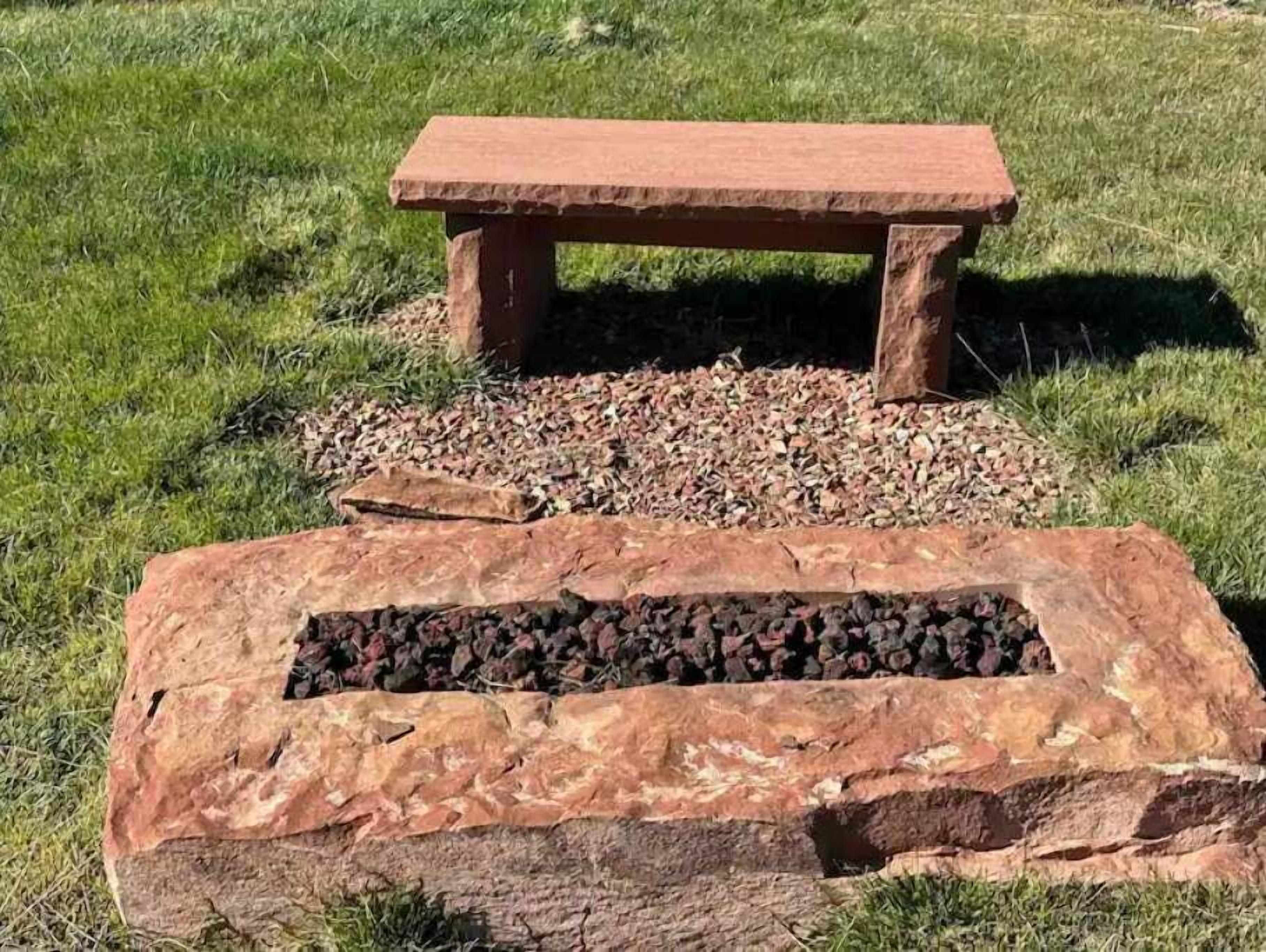 A stone bench with a rectangular stone base and a flat top.
