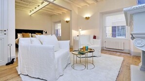 A spacious bedroom with a large bed, a bedside table, and a window. - Luxury & Charm between Pantheon and Spanish Steps (Roma)