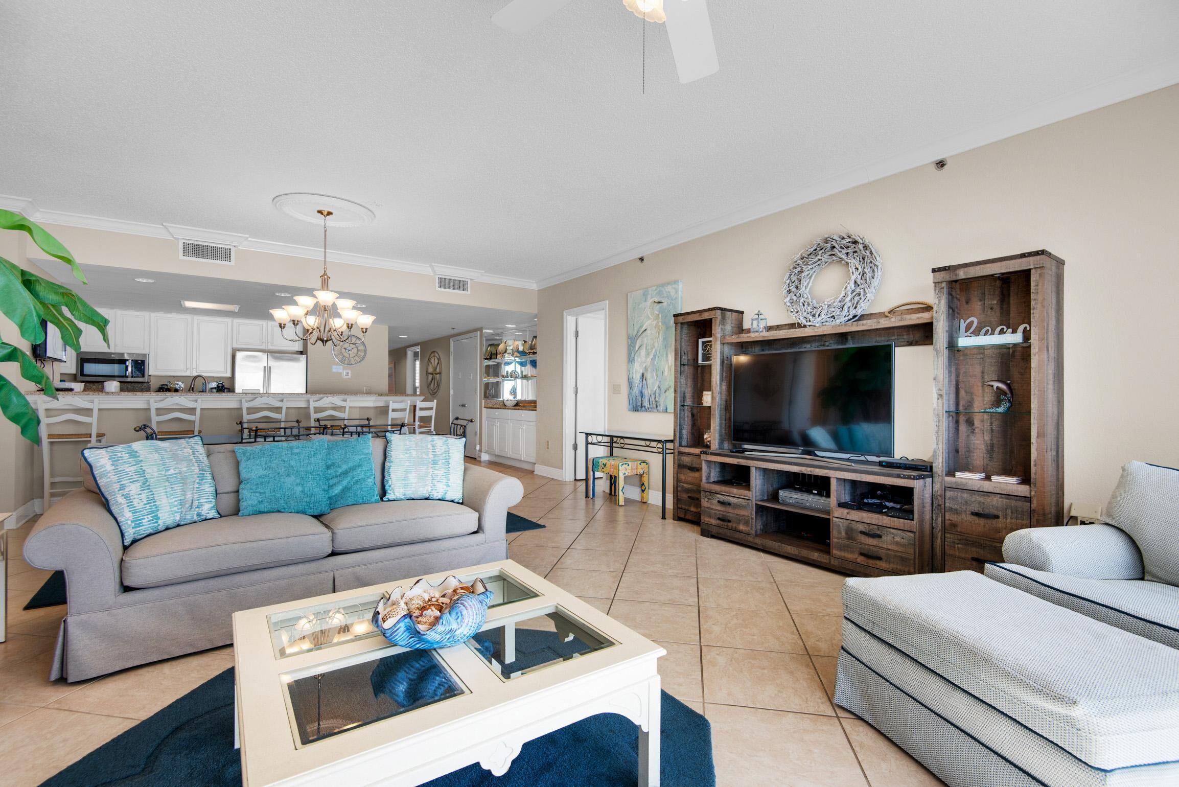 A living room with a sofa, coffee table, TV, and entertainment center.