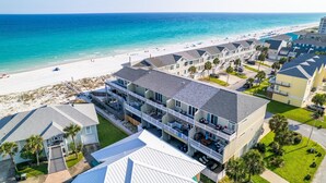 A beachfront hotel with multiple balconies, a pool, and a beach view. - Bonita Bay (Pensacola Beach)