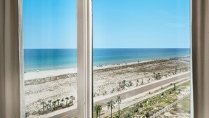 A beach view from a window with a clear sky. - Portofino Island Resort 5-1002 (Pensacola Beach)