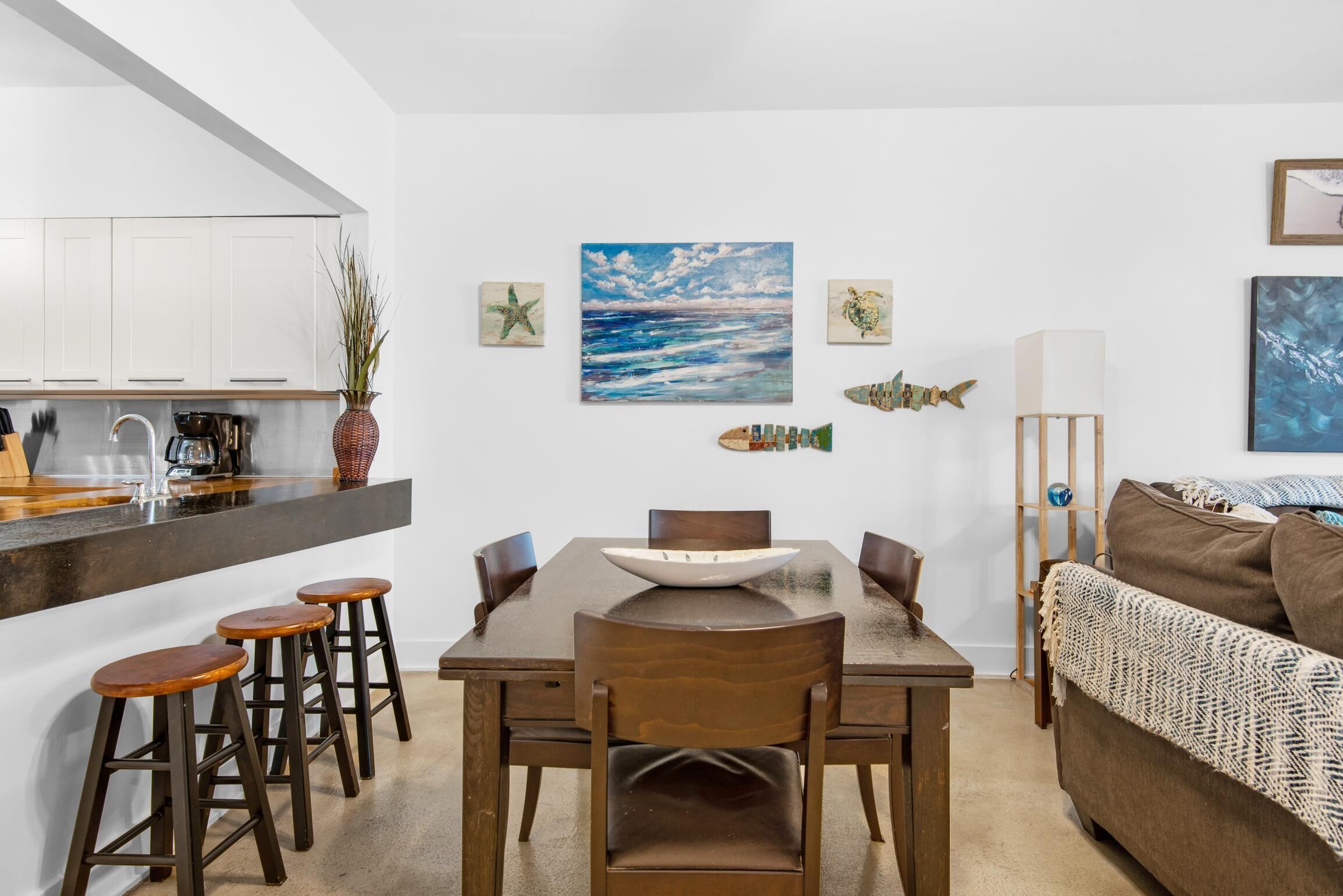 A compact living space with a kitchen area, dining table, and seating.