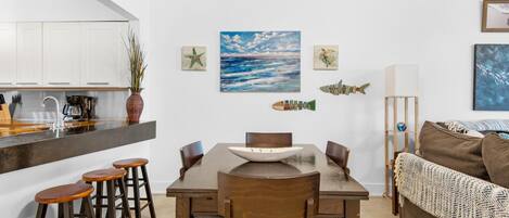A compact living space with a kitchen area, dining table, and seating.
