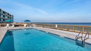 A swimming pool with a wooden deck and a view of the ocean. - Palm Beach Club 2-112 The Sugar Spot (Pensacola Beach)