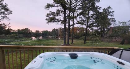 Secluded waterfront getaway with hot tub,fire pit, and private dock.