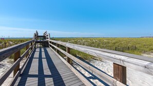 A wooden boardwalk leading to a beach with a clear blue sky. - Beachview 101- Beaches and Moonbeams (Navarre)