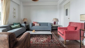A living room with a sofa, armchair, coffee table, and lamps. - Home2Book Bright Apt Las Palmas City Center (Las Palmas de Gran Canaria)