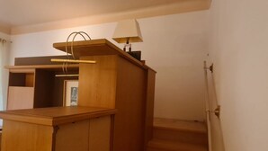 A wooden staircase leading to a landing with a lamp and a coat rack. - Cozy City Center Retreat 2BR Apt. Homelike Comfort (Vienna)