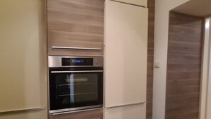 A kitchen with a built-in oven and a microwave. - Cozy City Center Retreat 2BR Apt. Homelike Comfort (Vienna)