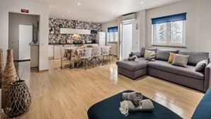 A modern apartment with a kitchen, dining area, and living room. - Cristal VIP Properties by Interhome (Albufeira)