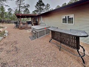 A covered patio area with outdoor furniture, a grill, and a hot tub. - Blue Sky by Ruidoso Vacation Rentals (Ruidoso)