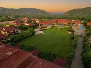 A resort with multiple buildings, a central lawn, and a swimming pool. - Ananta Spa & Resorts Jaipur (Jamwa Ramgarh)