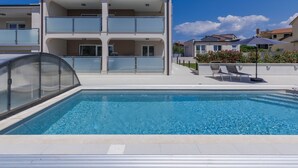 A modern two-story building with a swimming pool in the foreground. - Villa Galici by Interhome (Umag/Murine)