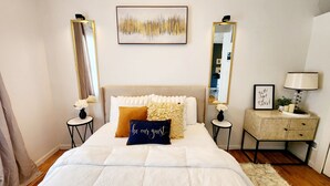 A bedroom with a large bed, two bedside tables, a dresser, and two mirrors. - Tranquil Tremont-Stay 3 nights & Enjoy 25% off 4th night (Cleveland)