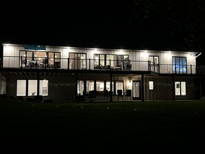 A modern two-story house with large windows and a balcony. - Luxurious lake home, new 4 bdrm, 3 bath 2 kitchens modern farmhouse on SRCL.org (Cold Spring)
