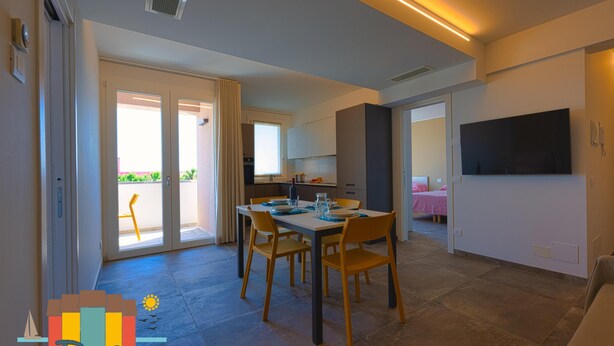 A modern apartment with a dining area, kitchen, and living space. - Fantastic new penthouse with seaview P 21 (Rosolina Mare)