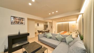 Comfort Apartment | Living area | 72-inch flat-screen TV with digital channels
