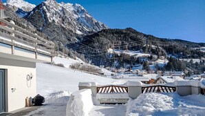 A snow-covered mountain landscape with a ski resort in the background. - Sandra Falch by Interhome (Flirsch)