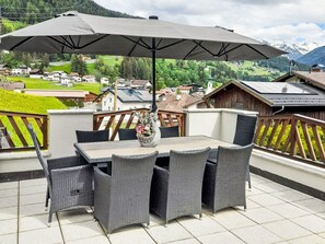 Relax on the outdoor terrace with a scenic view of the village and mountains.