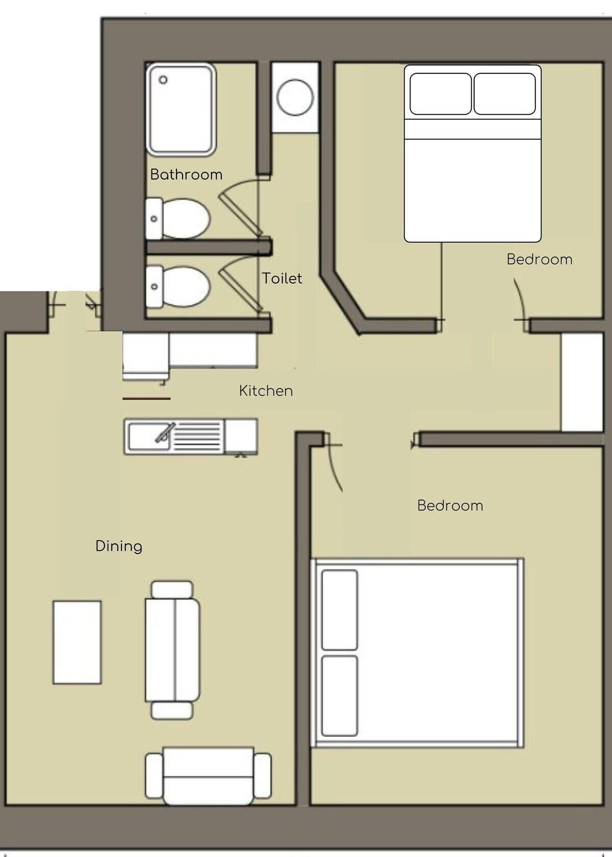 Grundriss eines Hotelzimmers mit Bad, Toilette, Küche, Essbereich und zwei Schlafzimmern.