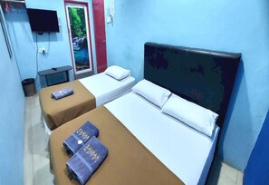 A hotel room with two beds, a TV, and a door with a poster. - OYO 90937 Tanjak Hotel (Alor Setar)
