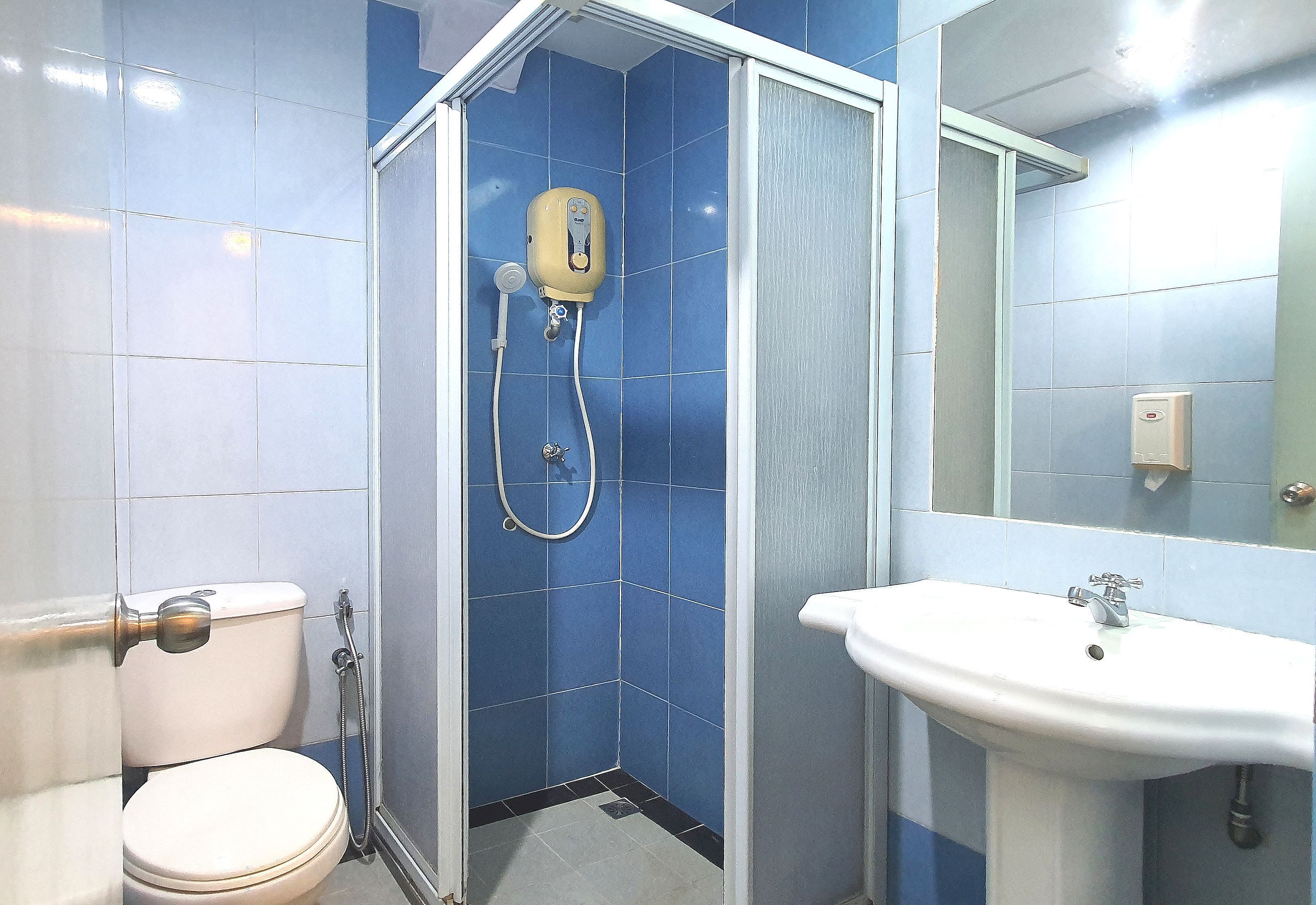 Ein Badezimmer mit Dusche, Toilette und Waschbecken.