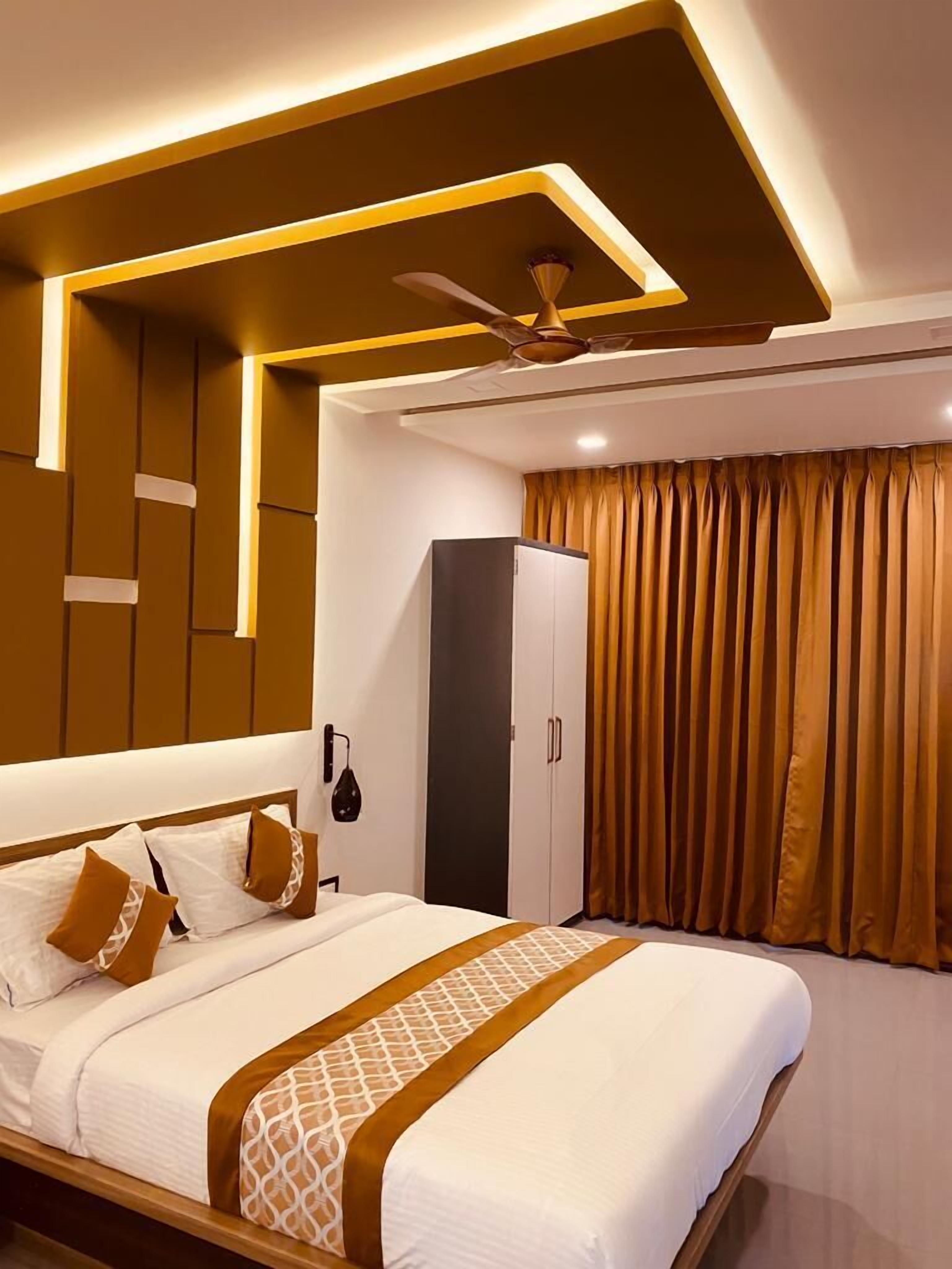 A modern bedroom with a bed, wardrobe, and curtains.