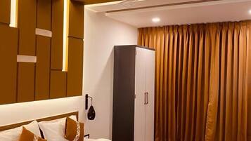 A modern bedroom with a bed, wardrobe, and curtains.