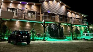 A two-story building with a balcony and a driveway. - Hollywood Palace Resort (Mahabaleshwar)