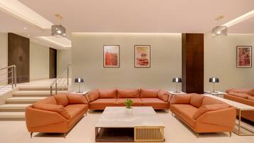 A modern living room with a sectional sofa, a coffee table, and two side tables.