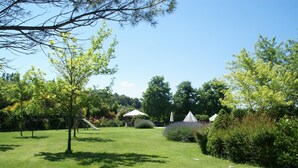 A well-maintained garden with a grassy lawn, a swing set, and a gazebo. - Apartment in Montone with Pool & Garden (Montone - Umbertide (pg))