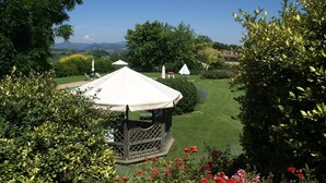 A gazebo with a white canopy in a lush garden with a clear view of the surrounding landscape. - Apartment in Montone with Pool & Garden (Montone - Umbertide (pg))