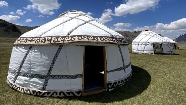 A yurt with a patterned entrance and a clear sky in the background. - Kel-Suu At-Bashy (Kel Suu)