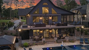 A large, modern house with a spacious outdoor area, including a pool and outdoor seating. - Luxe Lakefront Lodge w/ Pool, Hot Tub, Theater & Private Dock | Sleeps 21 (Sherrills Ford)