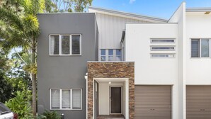 A modern two-story house with a grey and white exterior, a stone entrance, and a garage. - 600m to esplanade - Spacious + Everything you need (Pialba)