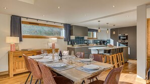 A modern kitchen with a dining area.