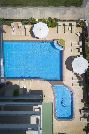Piscine extérieure en saison, parasols, chaises longues