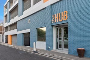 A building with a blue brick facade and a sign that reads "The HUB". - The Hub 602 (Cape Town)