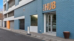 A building with a blue brick facade and a sign that reads "The HUB". - The Hub 602 (Cape Town)