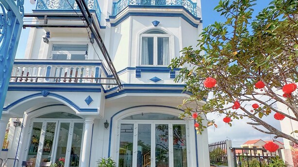 A two-story building with a balcony, large windows, and a pool area. - Blue Fish Villa (Da Nang)