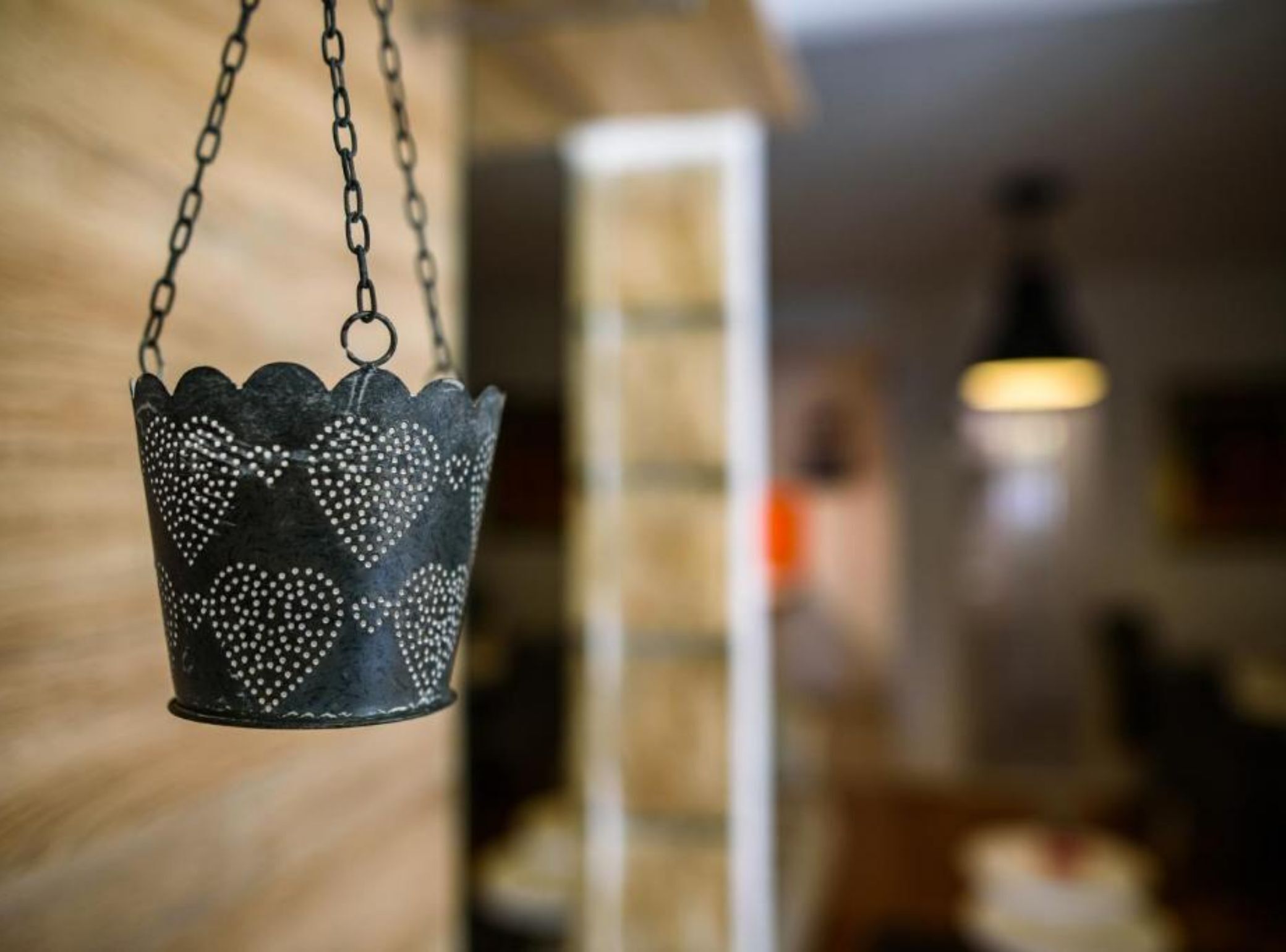 A hanging decorative item with a scalloped edge and dotted pattern.