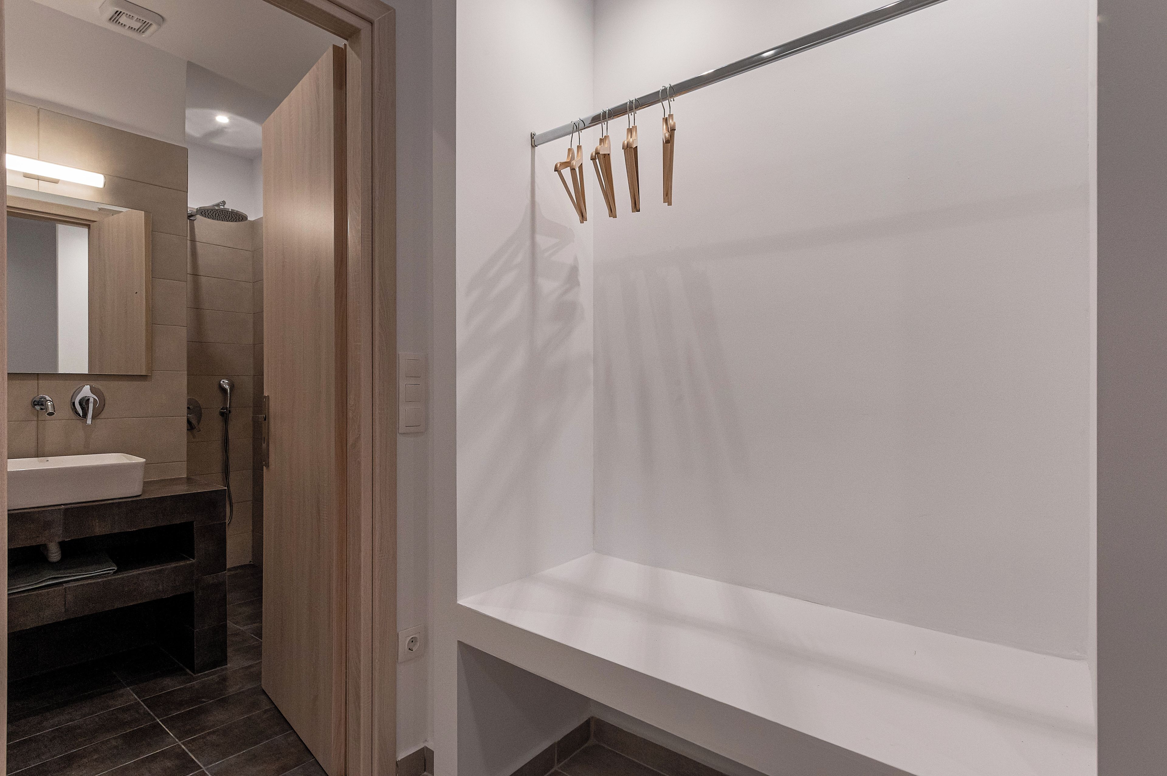 Un baño moderno con un espejo grande, un lavabo y una zona de ducha.