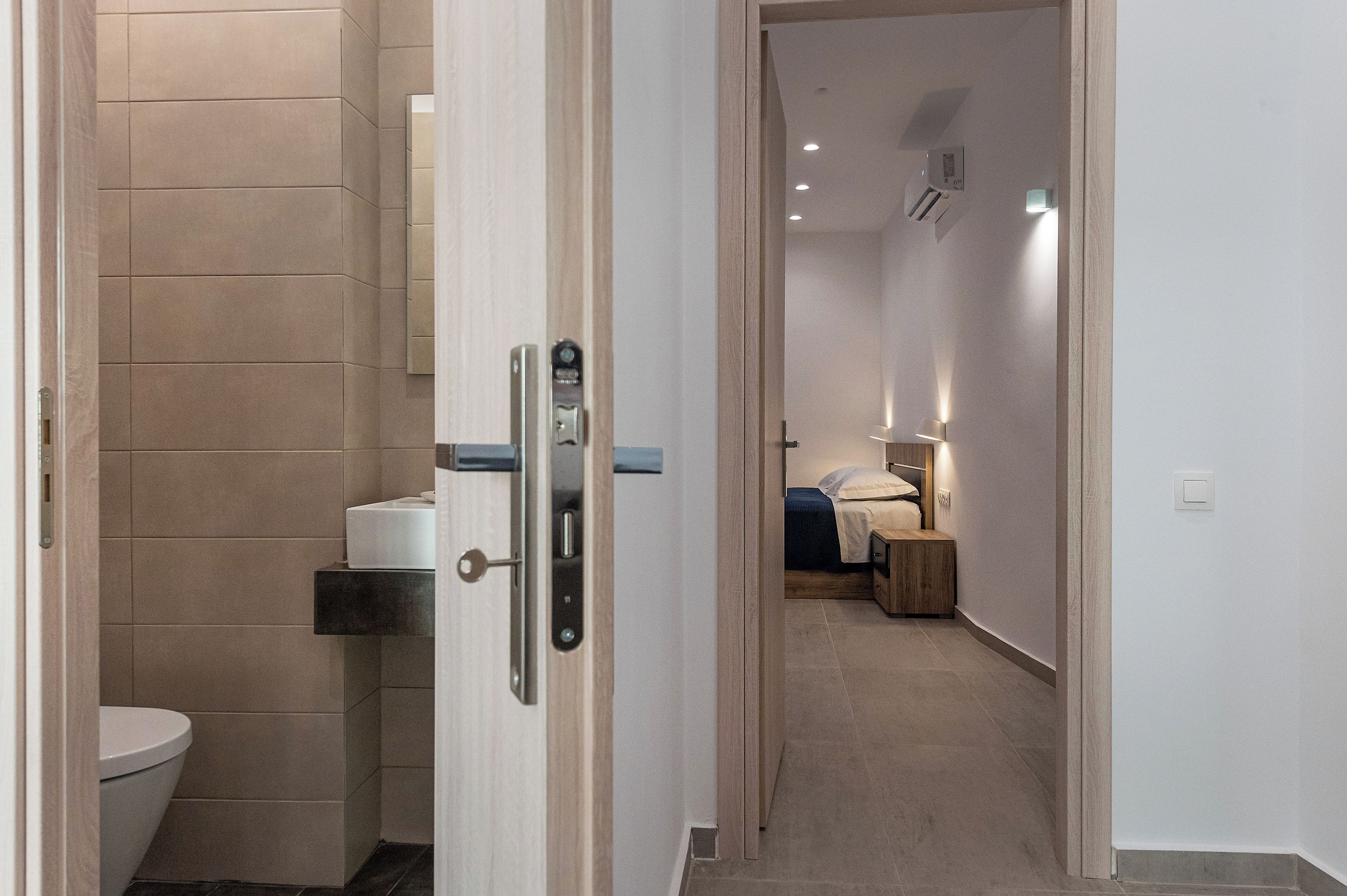 Ein modernes Badezimmer mit Toilette, Handtuchspender und Duschbereich.