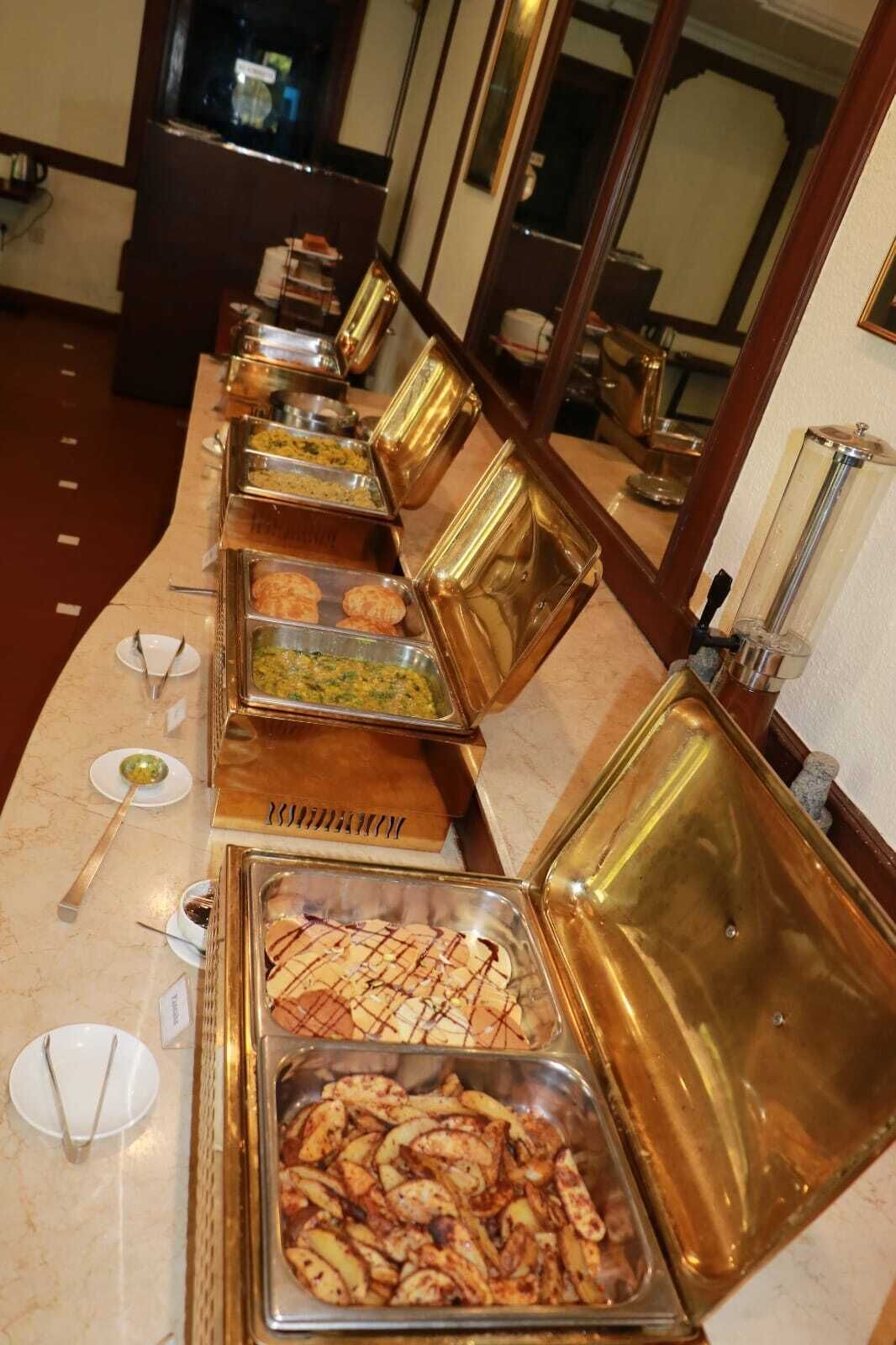 A buffet line with various food items in clear containers.