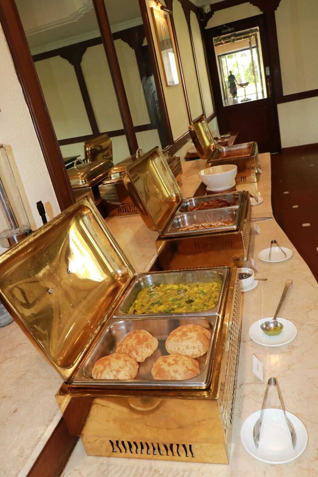 A buffet setup with various food items and utensils.
