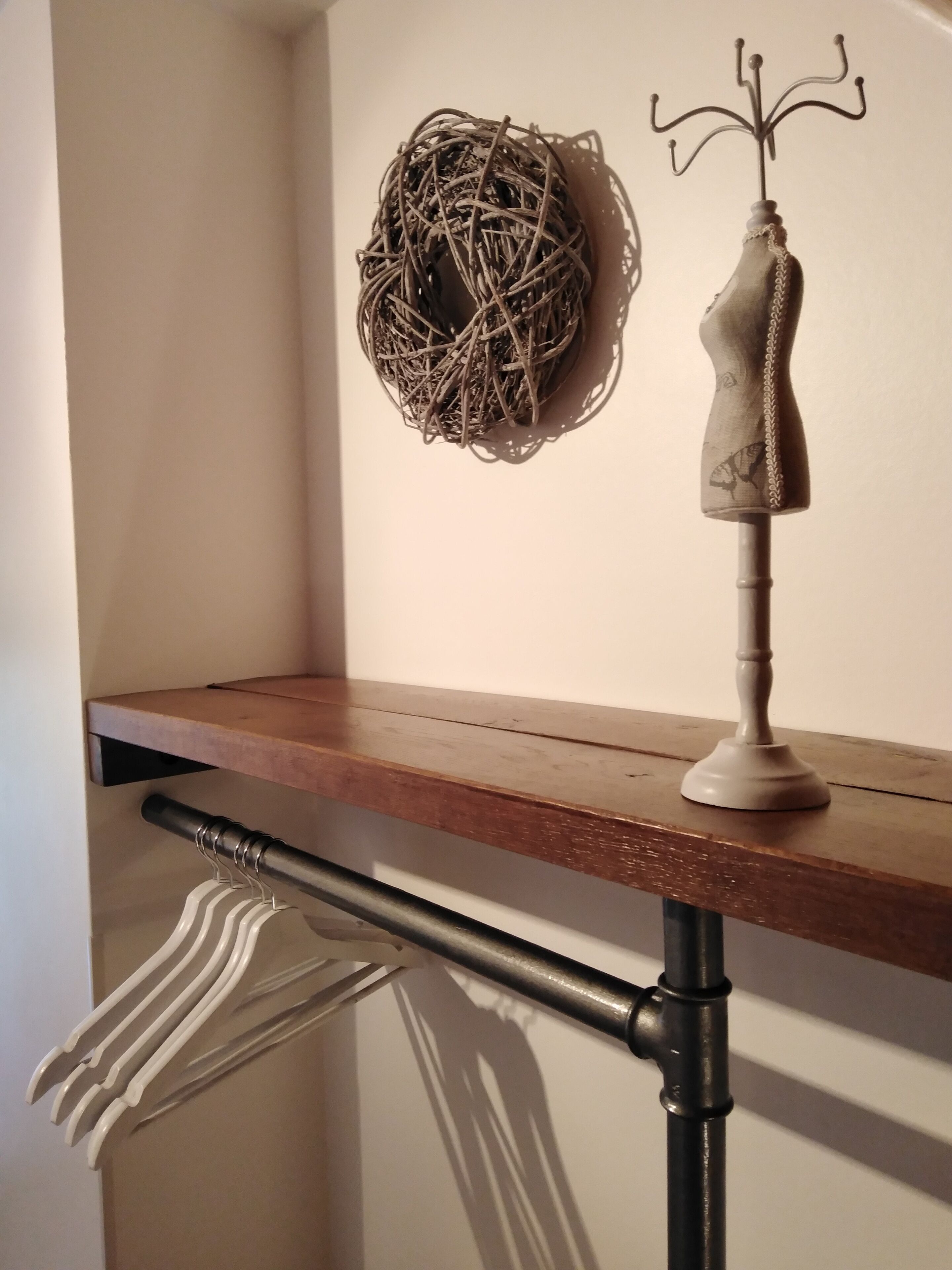 A wooden shelf with a decorative item and a white towel.