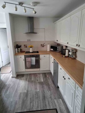 Fridge, microwave, coffee/tea maker, cookware/dishes/utensils