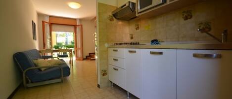 Fridge, microwave, coffee/tea maker, cookware/dishes/utensils