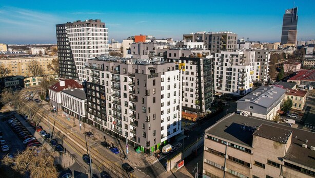 A high-rise residential building with multiple floors, balconies, and a parking area in front. - ShortStayPoland Skierniewicka B156 (Warsaw)