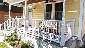A porch with white railings, a wooden ceiling fan, and a bench. - Walkable Elmwood Cottage, No Chores 2Bath 2BR 1Car (Buffalo)